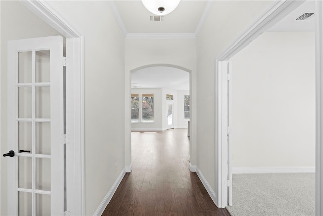 hallway with crown molding and dark hardwood / wood-style flooring