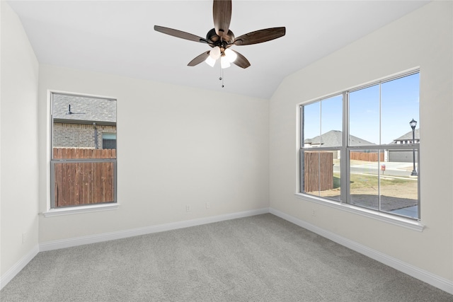 unfurnished room with ceiling fan, lofted ceiling, and carpet