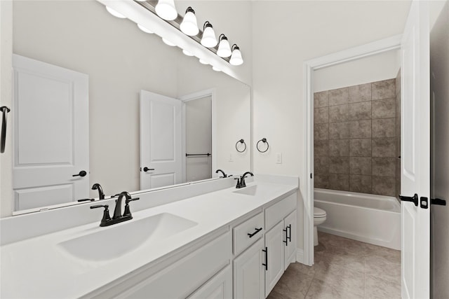 full bathroom featuring vanity, tiled shower / bath combo, tile patterned floors, and toilet