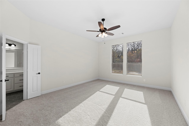 empty room with ceiling fan and light carpet