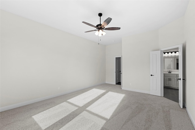 unfurnished bedroom with light colored carpet, ceiling fan, and ensuite bathroom