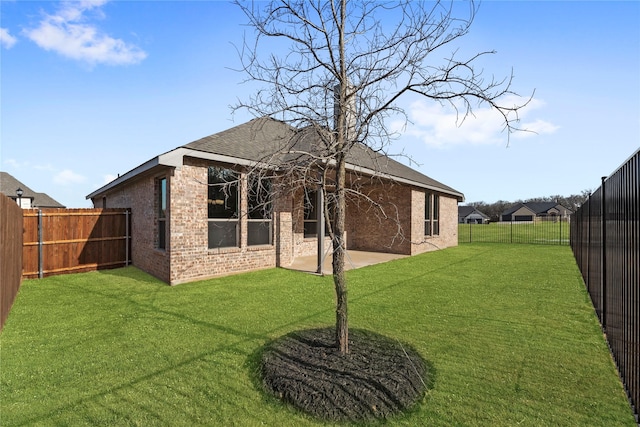 back of property featuring a yard and a patio