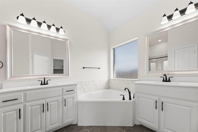 bathroom with lofted ceiling, shower with separate bathtub, tile patterned flooring, and vanity