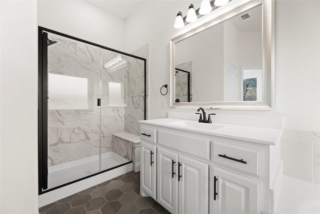 bathroom with vanity and a shower with shower door