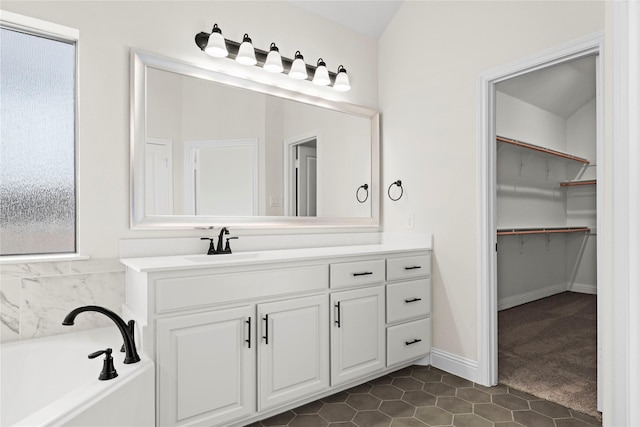 bathroom with vanity, a bathtub, and tile patterned floors