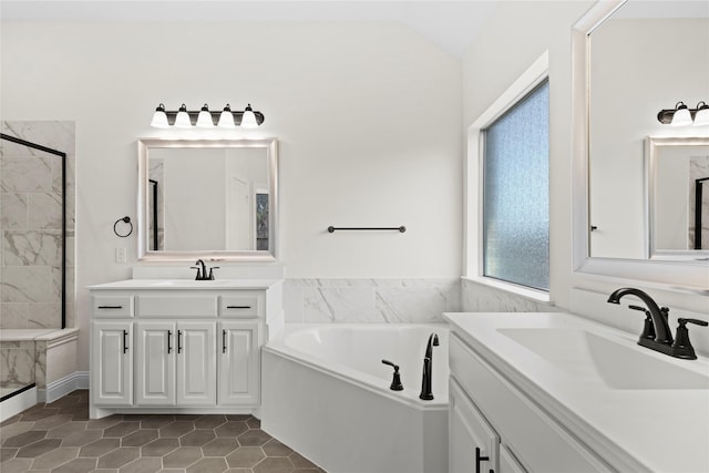 bathroom with tile patterned flooring, vanity, lofted ceiling, and separate shower and tub