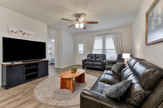 living room with ceiling fan and light hardwood / wood-style floors