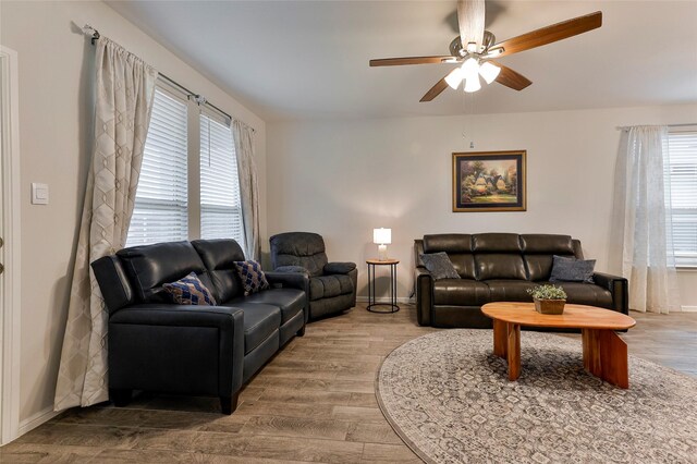 living room featuring ceiling fan and hardwood / wood-style floors