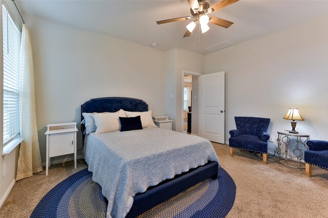 bedroom with a ceiling fan, visible vents, and carpet floors