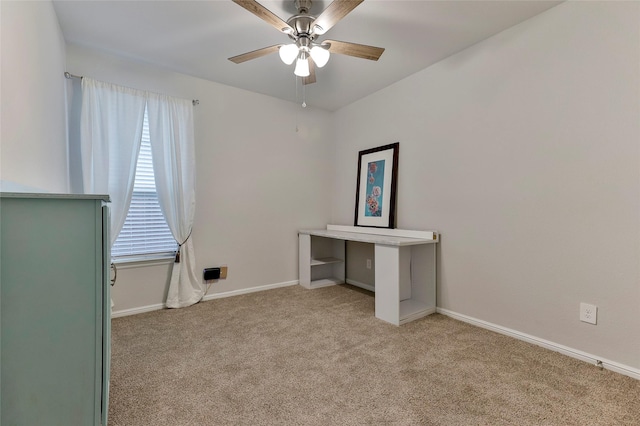 unfurnished office featuring light colored carpet and ceiling fan