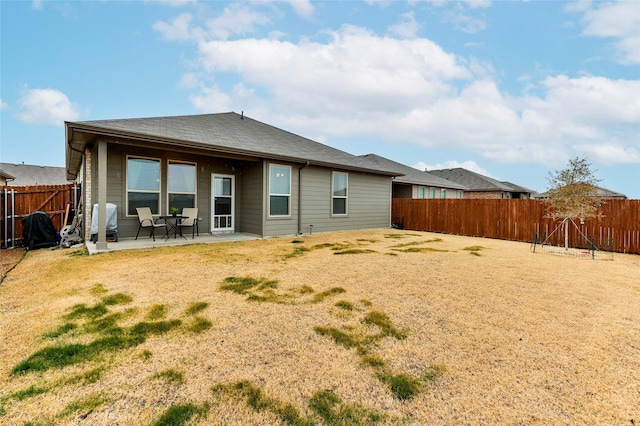 back of property featuring a fenced backyard and a patio