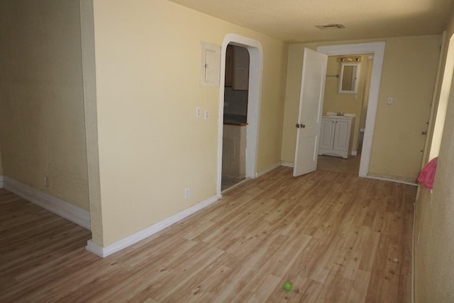 empty room with light hardwood / wood-style flooring