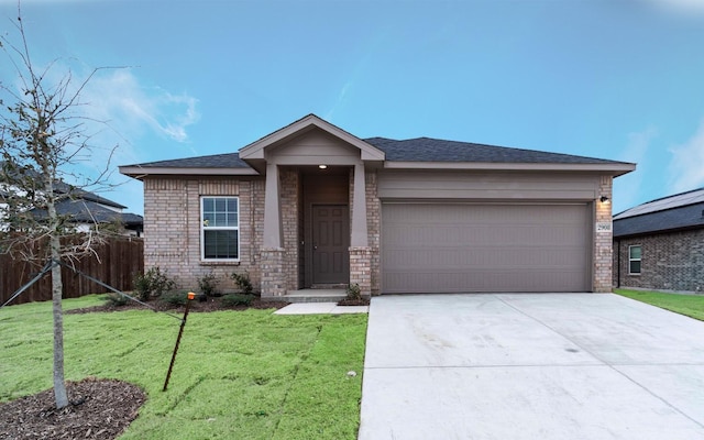 view of front of property featuring a garage, driveway, brick siding, fence, and a front yard