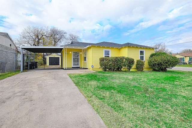 view of front facade with a carport and a front lawn