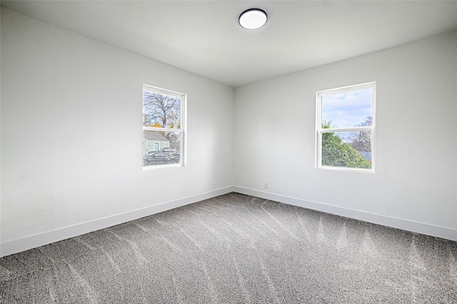 carpeted empty room with a healthy amount of sunlight