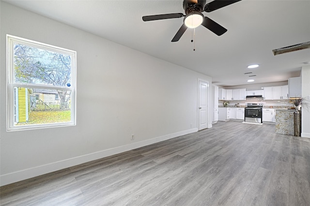 unfurnished living room featuring ceiling fan and light hardwood / wood-style flooring