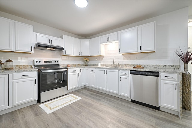 kitchen featuring sink, light stone counters, stainless steel appliances, light hardwood / wood-style floors, and white cabinets