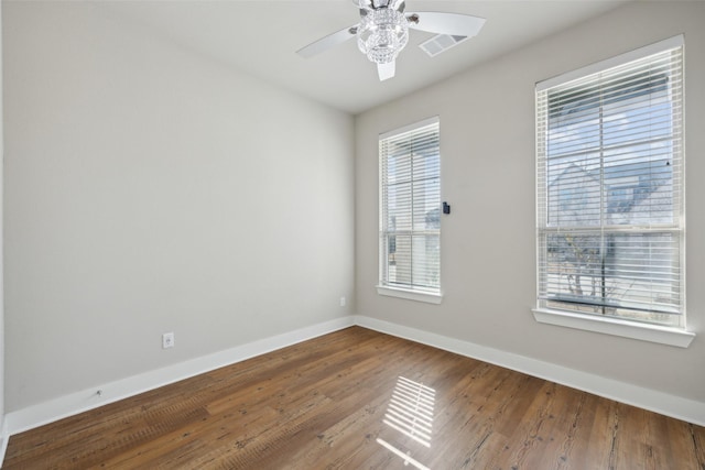 empty room with ceiling fan and hardwood / wood-style floors