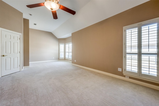 unfurnished room featuring carpet, visible vents, baseboards, and vaulted ceiling