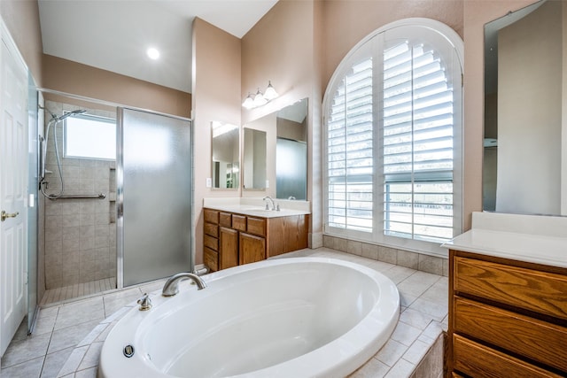 full bath featuring a stall shower, a garden tub, and vanity