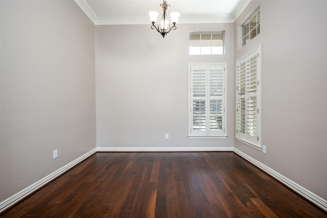 spare room featuring baseboards, ornamental molding, and dark wood finished floors