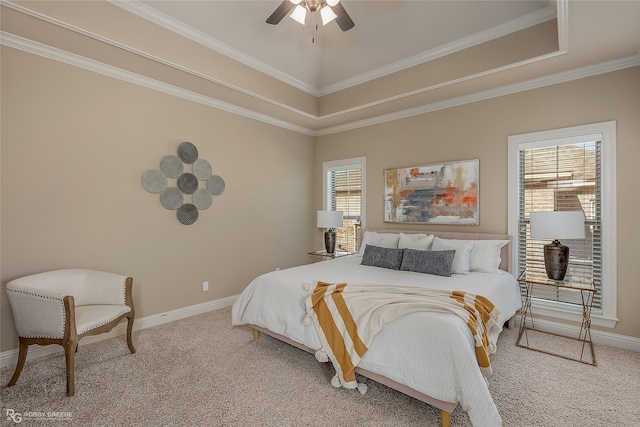 carpeted bedroom featuring crown molding, ceiling fan, and a raised ceiling