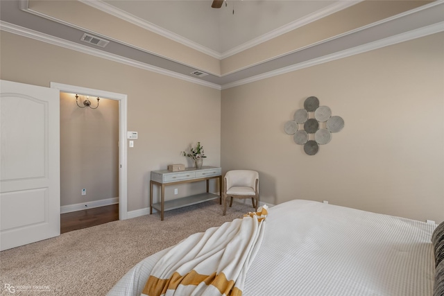 carpeted bedroom featuring ornamental molding, a raised ceiling, and ceiling fan