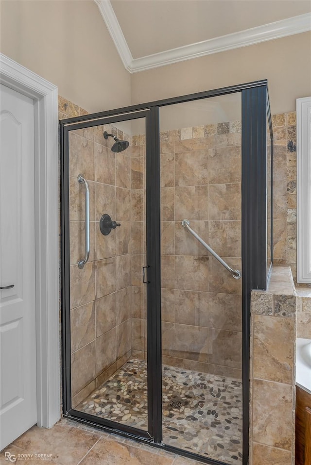 bathroom with a shower with door and ornamental molding