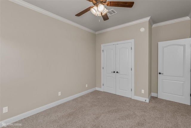 unfurnished bedroom featuring carpet floors, ornamental molding, a closet, and ceiling fan