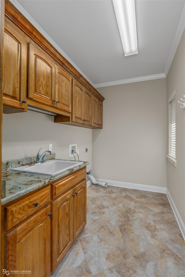 kitchen with ornamental molding, sink, and light stone counters