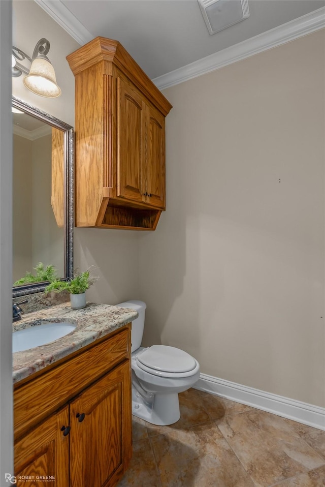 bathroom featuring vanity, crown molding, and toilet