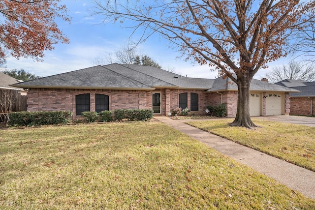 single story home featuring a garage and a front lawn