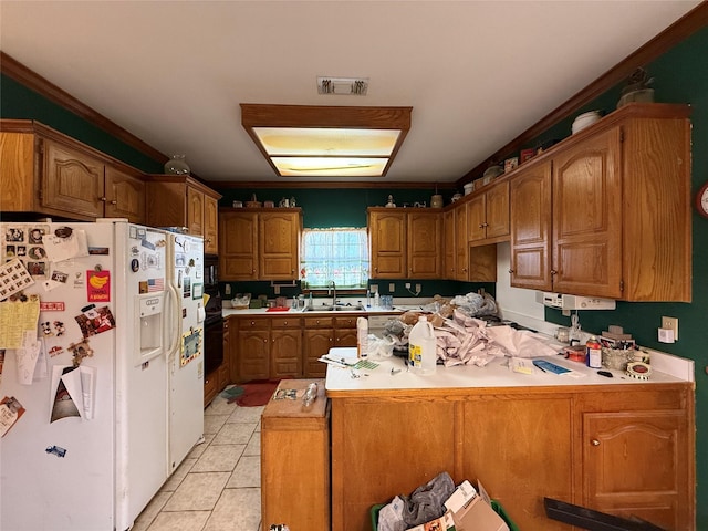 kitchen featuring visible vents, light tile patterned flooring, a sink, white fridge with ice dispenser, and a peninsula