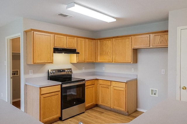 1013 Caleb St, Burleson, TX 76028 - kitchen featuring stainless steel electric stove, under cabinet range hood, light countertops, and light wood-style flooring