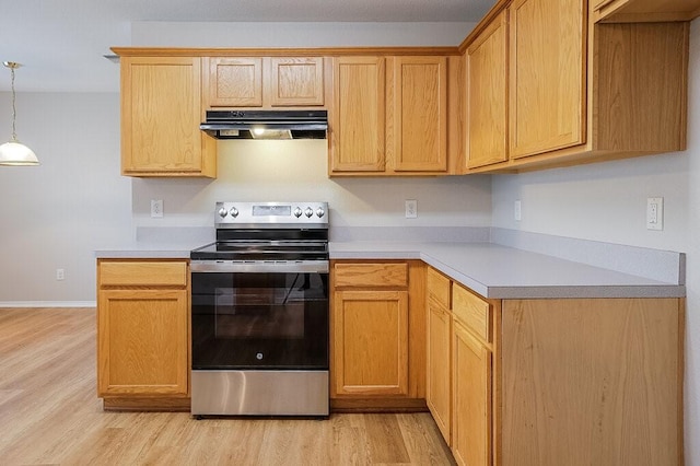 1013 Caleb St, Burleson, TX 76028 - kitchen featuring stainless steel range with electric cooktop, under cabinet range hood, light countertops, and light wood-style floors