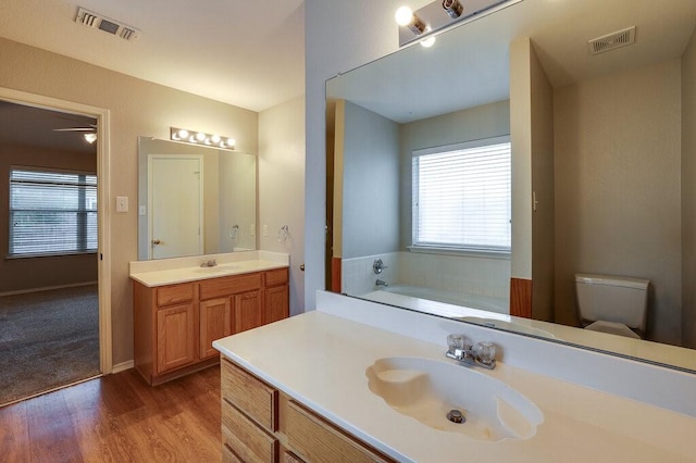 1013 Caleb St, Burleson, TX 76028 - full bathroom featuring vanity, a garden tub, and wood finished floors