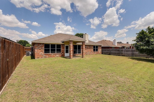 1013 Caleb St, Burleson, TX 76028 - back of property featuring a chimney, brick siding, a fenced backyard, and roof with shingles