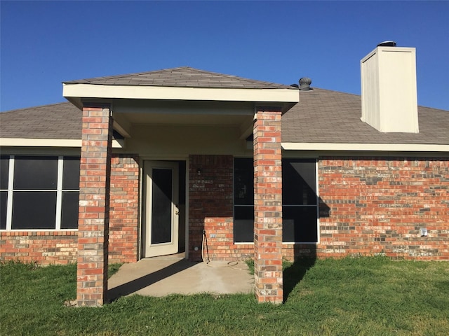 rear view of property with a lawn