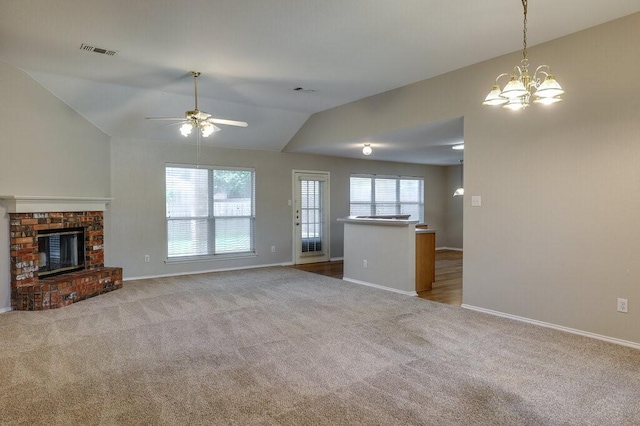 1013 Caleb St, Burleson, TX 76028 - unfurnished living room featuring carpet floors, ceiling fan, a fireplace, lofted ceiling, and a chandelier