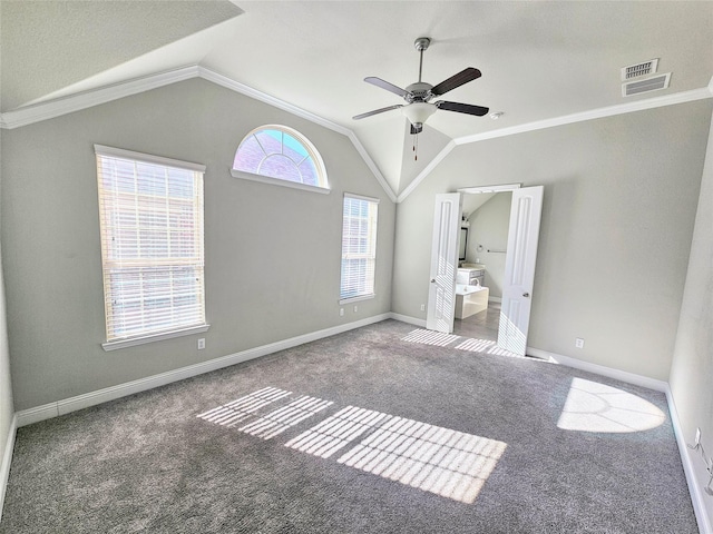 unfurnished bedroom featuring lofted ceiling, ornamental molding, ceiling fan, and ensuite bathroom