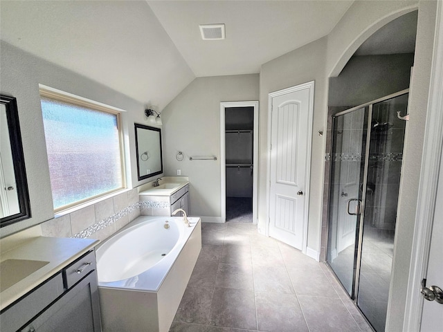 bathroom featuring lofted ceiling, separate shower and tub, tile patterned flooring, and vanity