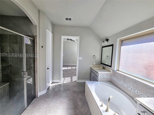 bathroom featuring lofted ceiling, tile patterned flooring, vanity, separate shower and tub, and ceiling fan