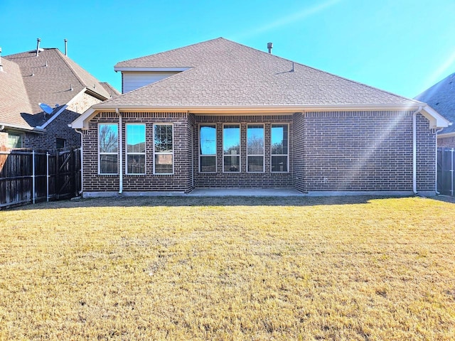 rear view of house featuring a lawn