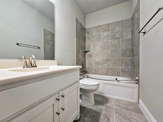 full bathroom featuring tiled shower / bath, vanity, and toilet