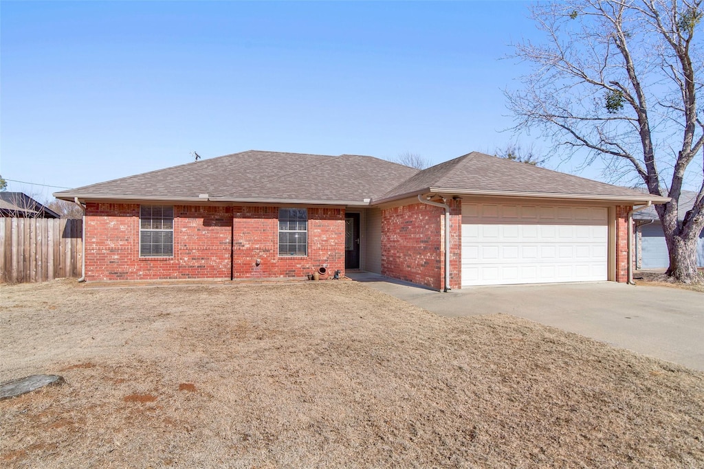 ranch-style house with a garage and a front lawn