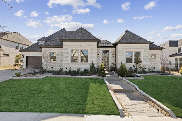 view of front facade with a garage and a front lawn