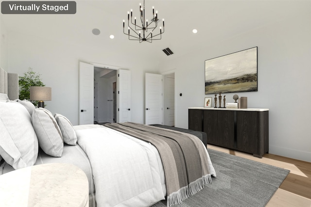 bedroom with a chandelier and light hardwood / wood-style flooring