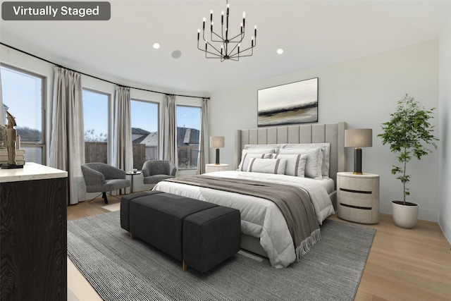 bedroom featuring a chandelier and light wood-type flooring