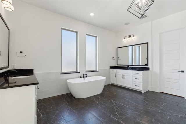 bathroom with vanity and a bathtub