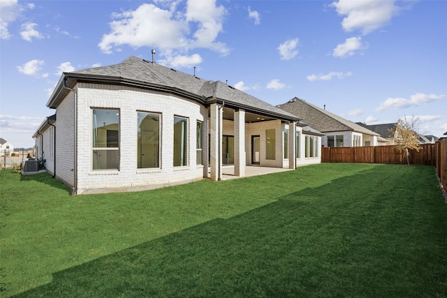 back of house with a yard, central AC unit, and a patio area